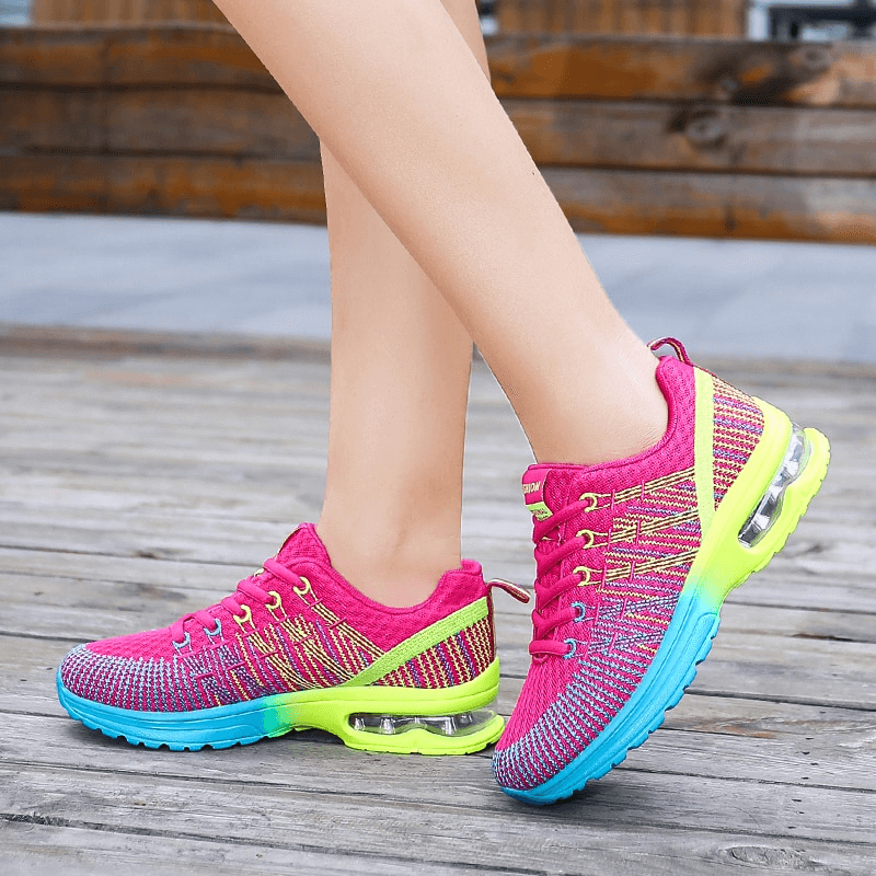 Bright pink mesh women's sneakers with neon green soles, ideal for sports and active days, showcasing breathable design and style.